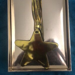 Coach gold star bag charm